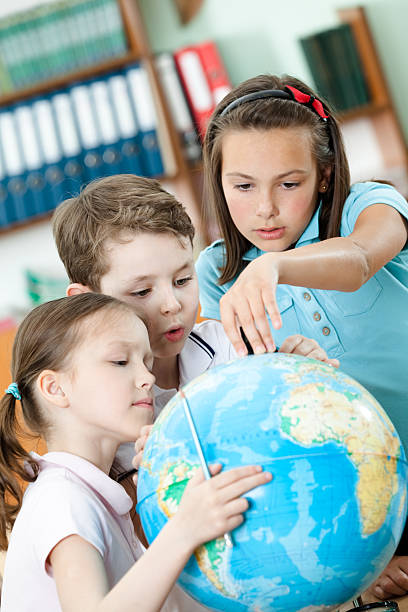 istock Classmates help each other to find something at the globe 158916079