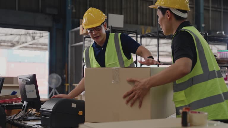 Group of warehouseworkers in a warehouse getting products ready for customers.