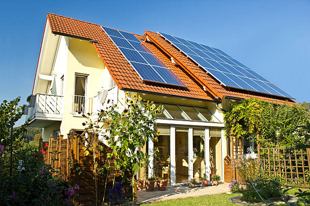 Solar panels on roof of house in late summer stock photo