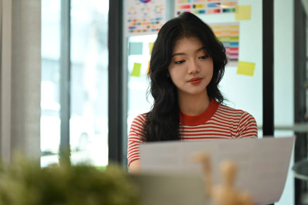 istock Young creative woman working with color palette, choosing color samples for design project at graphic studio. 1589189254