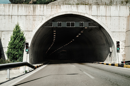 tunnel entrance on the mountain road, green traffic light