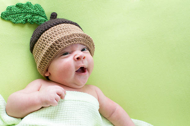 istock baby lying on green bed 158922377