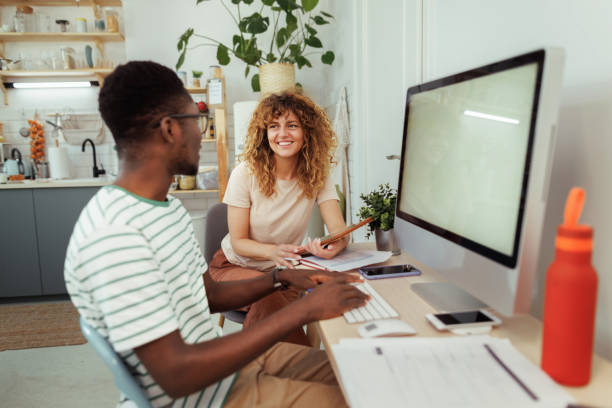 istock Young smiling couple working together at home office 1589238295