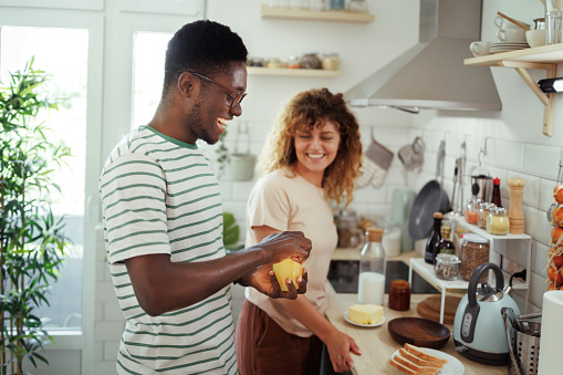 Young smiling couple enjoying their time together in a domestic kitchen