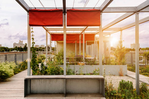Pergola Roof Terrace Garden. Metal Modern Pergola Awning on Roof Building with Red Fabric on Urban Terrace. Patio Garden Roof House.