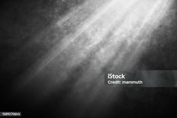 White And Gray Smoke Against Black Background With Light Beams Stock Photo - Download Image Now
