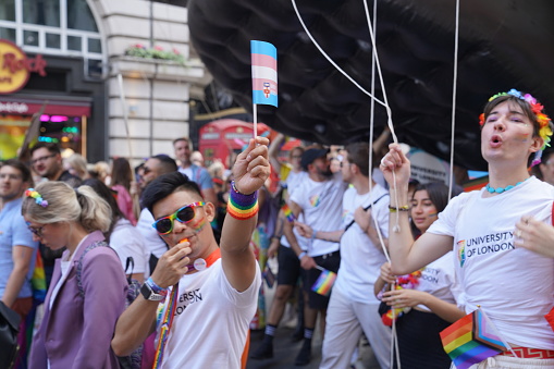 The trans and intersex-inclusive pride flags fly on Regent Street in London, UK. Pride in London 2023 stock photo. The Pride in London - LGBT Parade and street marches took place on Saturday, 1st of July 2023 in various locations in central London, England. Huge crowds turned out for the LGBT+ celebration with a march through the capital. LGBT+ communities and individuals came together again on July 1st 2023 in London, England. Stock photography captured by London-based photographer & photojournalist Can Aksoy.