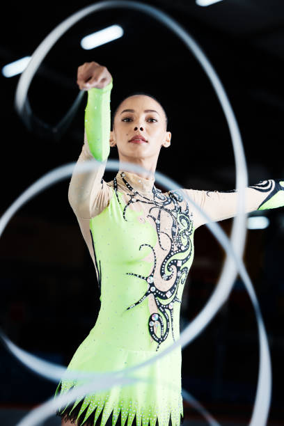 istock Gymnastics, dance performance and woman with ribbon for rhythmic movement, training and exercise. Aerobics practice, sports and female person in action for competition, workout and creative dancing 1589287316