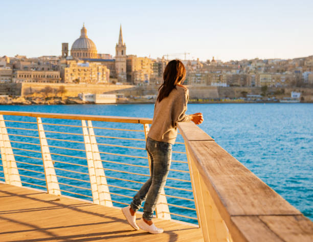 Valletta Malta city Skyline, colorful house balcony Malta Valletta, panoramic view over Valletta Asian women watching sunset at Valletta Malta city Skyline, colorful house balcony Malta Valletta, panoramic view over Valletta Malta old town at sunset malta stock pictures, royalty-free photos & images