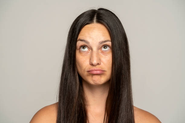 istock A young woman thinks suspiciously and looks up 1589310920