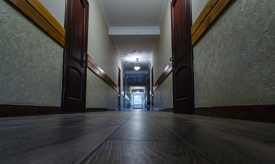 corridor with closed doors of an empty hotel without people during quarantine