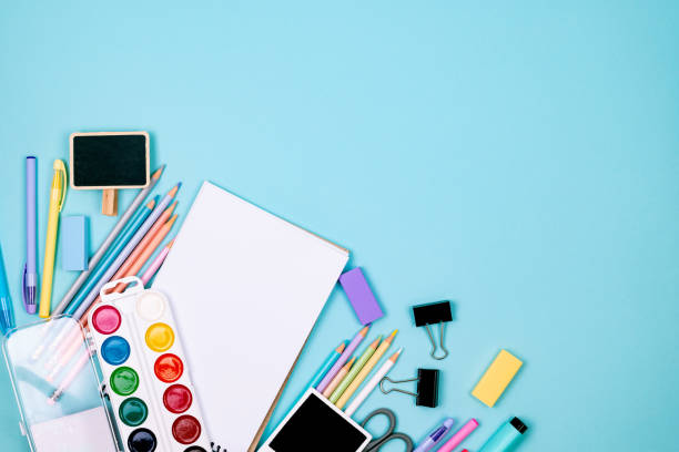 istock School notebook and various stationery on blue background. 1589313468