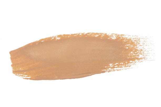 istock Gently beige strokes and texture of face highlighter or acrylic paint isolated on white background 1589320384