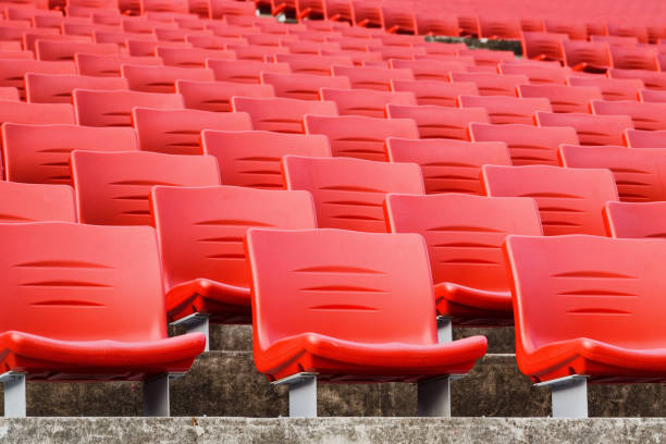 istock Rows of empty seats in a stadium. Red plastic seats 1589340639