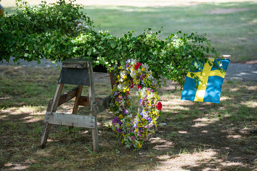 Image of Traditional midsummer pole with Swedish flag awaits the rising ceremony.