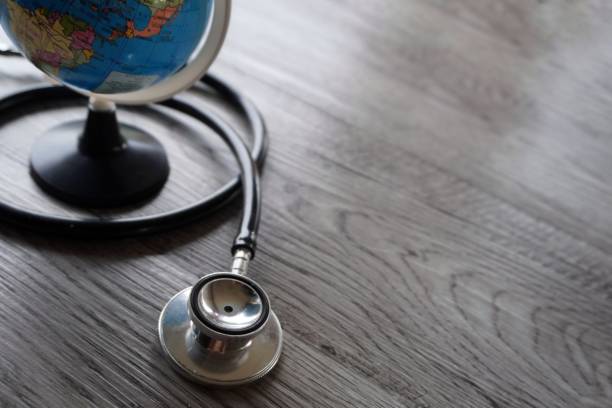 istock Selective focus image of stethoscope and world globe with copy space. 1589348911