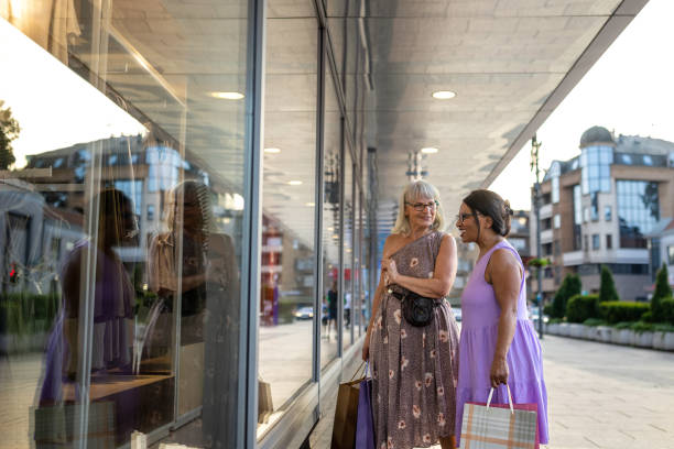 istock Two women window shopping together 1589348937