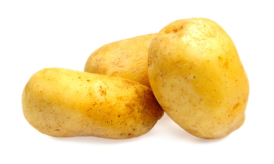 Washed potatoes isolated on a plain white background.