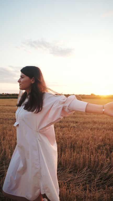 Playful young woman enjoying the sunset.