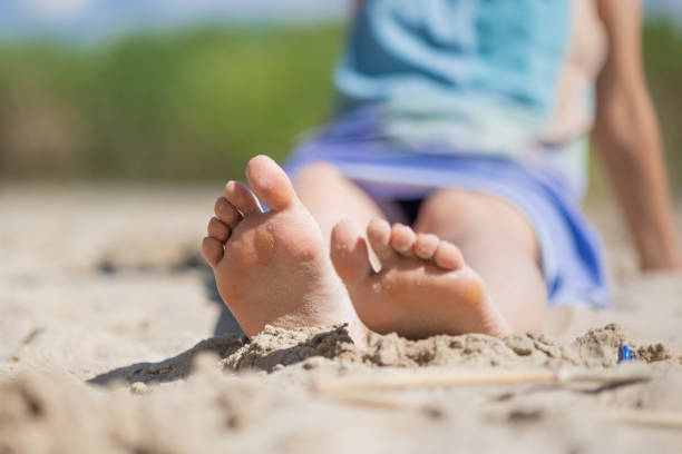 istock Young woman sitting on the beach 1589356591