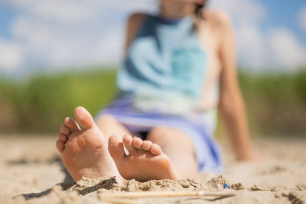 Only young woman sitting on the beach. A lake in south-eastern Poland.