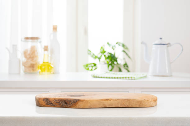 istock Defocused modern kitchen counter and wooden podium for product display 1589379563