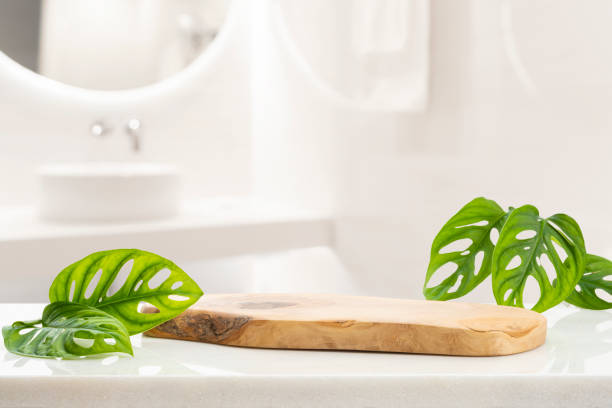 Wooden podium for bathing and spa products in defocused bathroom stock photo