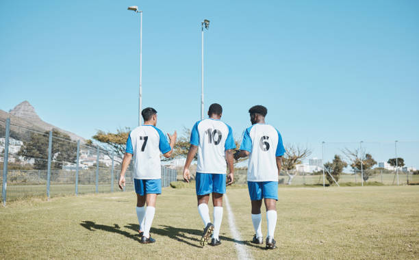 istock Soccer, team and walking on field with back or conversation at training or competition in out with grass. Fitness, teamwork and stadium with football player after game or collaboration at club. 1589384014