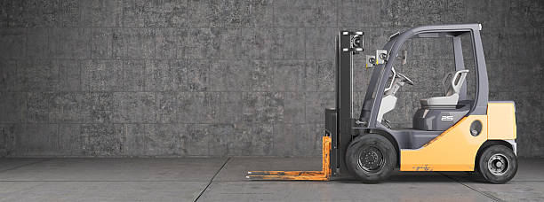 Forklift truck standing on industrial concrete wall background stock photo