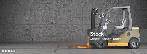 Forklift Truck Standing On Industrial Concrete Wall Background Stock Photo - Download Image Now