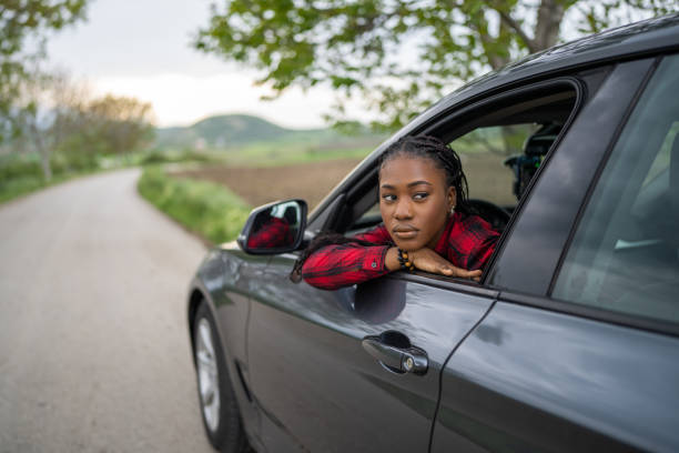 istock Woman sitting in a car 1589387117