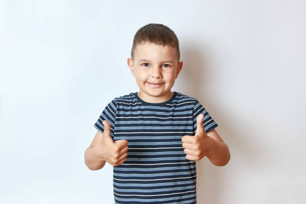 istock A handsome smiling boy shows his hands to his liking. 1589394796