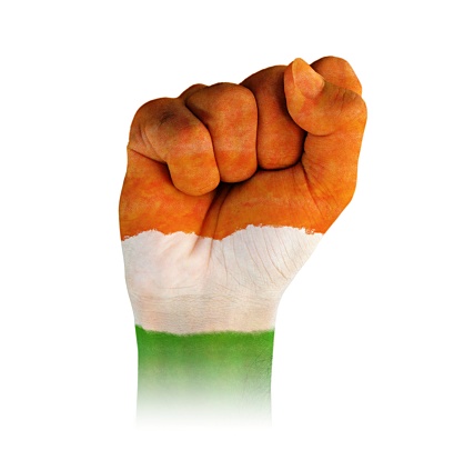 A horizontal cutout of a fist of hand painted in three vibrant colored bands in orange, white and green. . The image denotes the concept of unity, fervour, zeal, confidence, strength and determination.There is no text and Copy space for text. These colors are in the flag of India, Niger and also of Ireland and Côte d'Ivoire (Ivory Coast) country. Can be used for national festivals, events, national teams related backdrops of these countries like Republic Day, Independence Day celebrations.
