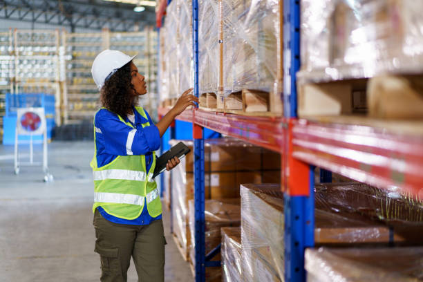 istock Female warehouse worker inspecting an inventory. 1589408259