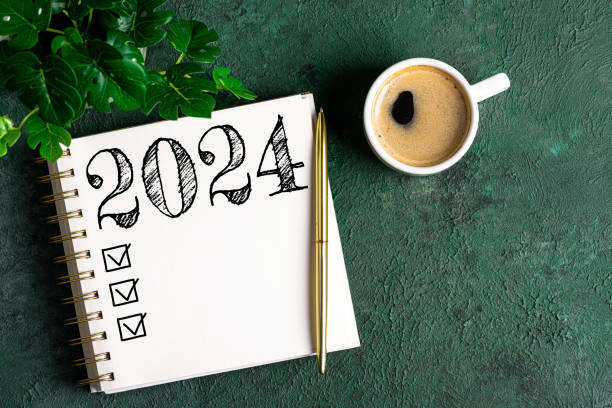 istock New year resolutions 2024 on desk. 2024 resolutions list with notebook, coffee cup on table. Goals, resolutions, plan, action, checklist concept. New Year 2024 template 1589408323