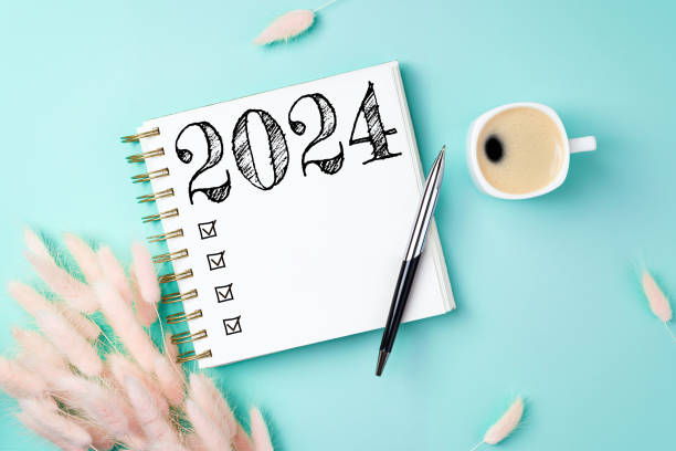 istock New year resolutions 2024 on desk. 2024 resolutions list with notebook, coffee cup on yellow table. Goals, resolutions, plan, action, checklist concept. New Year 2024 template 1589408786