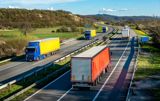 istock Transportation Trucks in lines passing 1589412540