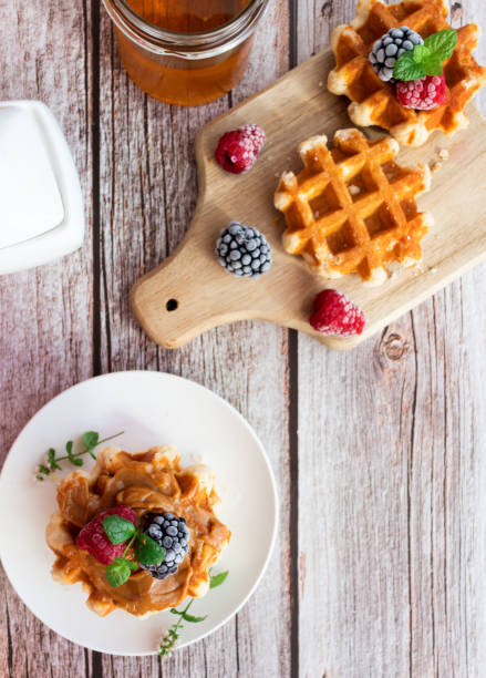 istock Belgian waffles with berries. Morning. On a wooden background 1589414687