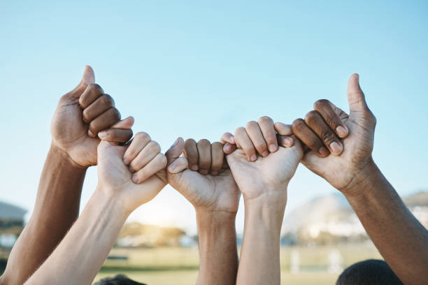 istock Fist, hands and group with diversity for outdoor celebration or team building together for support, motivation and solidarity. Hand, ready for sport or teamwork with community of people on blue sky 1589415216