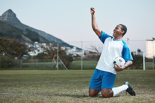 Sports, soccer ball and man celebrate goal on field for competition or training outdoor. Black male athlete football player, pitch and game celebration for sport achievement, success or win mockup