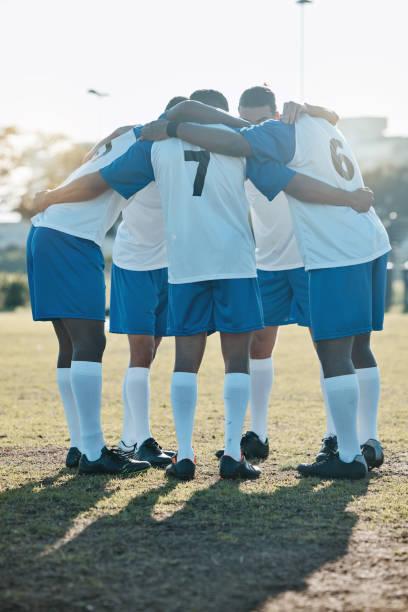 istock Soccer, support or team in a huddle for motivation, goals or group mission on a field for a sports game. Unity, stadium or football players planning a strategy, exercise or training for fitness match 1589420102