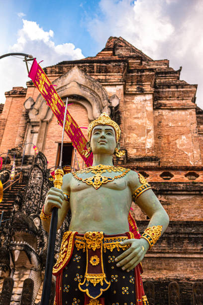 Colored statue of Thai Royal person holding weapon in front of Wat Chedi Luang temple in Chiang Mai Province, Northern Thailand
sculpture
Immerse yourself in the captivating world of Thai Buddhist mythology with this collection of stunning photographs. Explore the intricate and awe-inspiring statues of divinities from Thai Buddhism, captured in the temples of Thailand. From the serene and compassionate figures of the Buddha to the fierce and protective deities, each statue tells a story of faith, devotion, and spiritual significance. These sacred sculptures, adorned with vibrant colors and intricate details, are a testament to the rich cultural heritage and deep-rooted spirituality of Thailand. Whether you are a collector, an art enthusiast, or simply seeking to bring a touch of tranquility and inspiration into your space, these images offer a glimpse into the mystical realm of Thai temple art. Discover the beauty, symbolism, and profound meaning behind each statue as you embark on a visual journey through the temples of Thailand. estatua coloreada de la realeza tailandesa sosteniendo un arma frente al templo wat chedi luang en la provincia de chiang mai, norte de tailandia
estatuas sagradas de la mitología budista tailandesa y el folclore: un viaje a través de los templos de tai