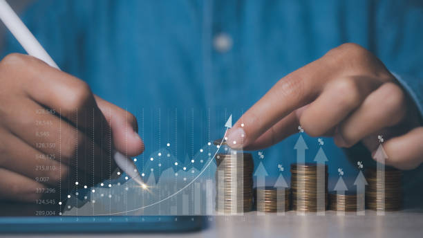 istock Businessman stacking coins with screen forex trading graph financial data. Goal business profit graph development. Stock market, financial growth report. 1589431399