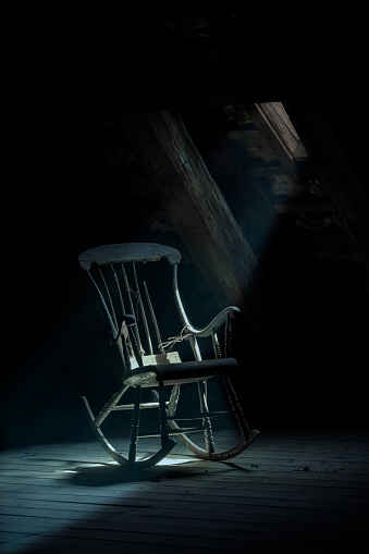 Old rocking chair in spooky house