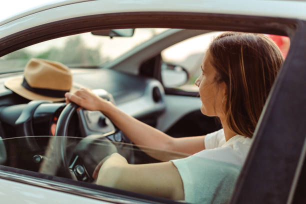 istock Cheerful female driver in the car 1589444778