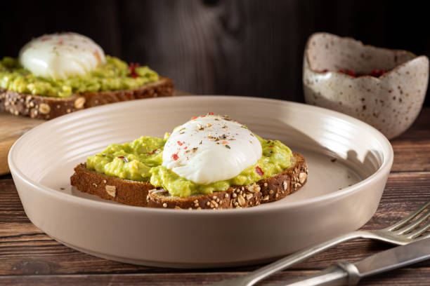istock Wholemeal toast with avocado and poached egg. 1589454383