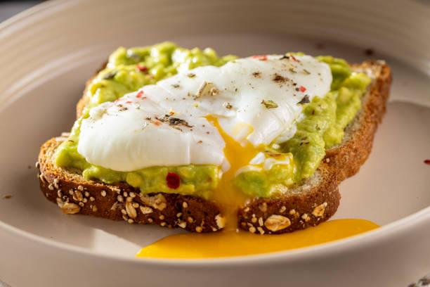 istock Wholemeal toast with avocado and poached egg. 1589454909