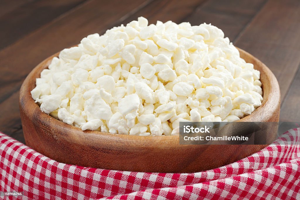 cottage cheese in rustic wooden plate cottage cheese in rustic wooden plate on kitchen table Bowl Stock Photo