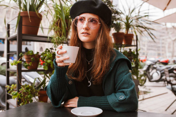 istock Stylish woman sitting in cafe 1589468952