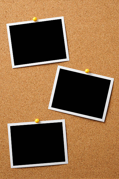 istock Three blank photos pinned on cork board 158946937